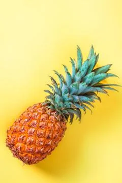 Pineapple on yellow background vertically Stock Photos