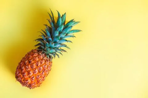 Pineapple on yellow light background Stock Photos