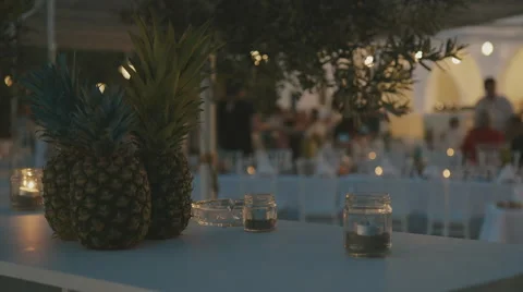 Pineapples and decorations at summer bar/restaurant at dusk Stock Footage 65217786