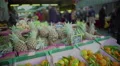 Pineapples and tangerines lying in boxes at food market, exotic fruit trade HD Footage