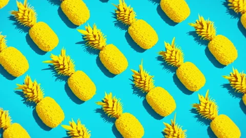 Pineapples on a vivid colors background ideal for summer footage Stock Footage 237108739