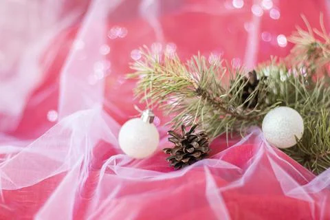 Pinecone with Christmas tree branches and Christmas balls on red background w Stock Photos