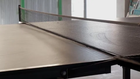 Ping Pong Ball Bouncing on Table Tennis Table in Bright Indoor Game Room Stock Footage 336482318