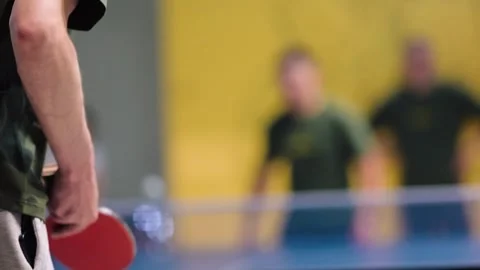Ping pong match takes place in a sports center with players showing skills and Stock Footage 336319720