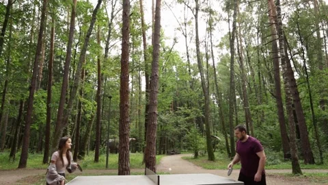Ping pong players playing table tennis, enjoying a casual match, outdoor sp.. Stock Footage 283905946