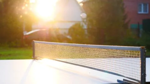 Ping pong table and net closeup in sunset light. Shadow Stock Photos