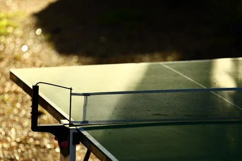 A ping pong table with a ball in the background Stock Photos