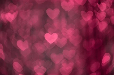 Pink abstract bokeh background in the shape of hearts. Valentines day texture Stock Photos