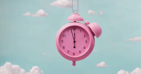 Pink alarm clock closeup with clouds. Pink clock swings like a pendulum  Stock Footage 263239662