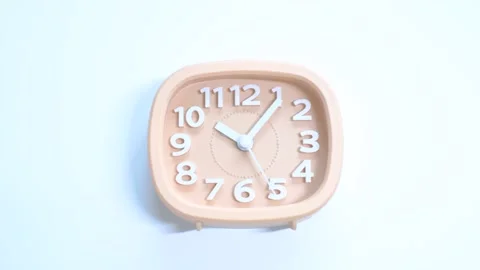 Pink alarm clock on white background close-up, top view. Stock Footage 228670468