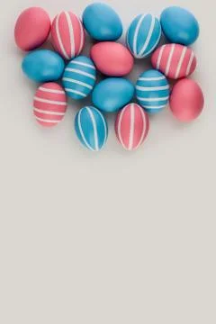 Pink and blue striped Easter eggs on a light background. Copy space. Fotos de archivo