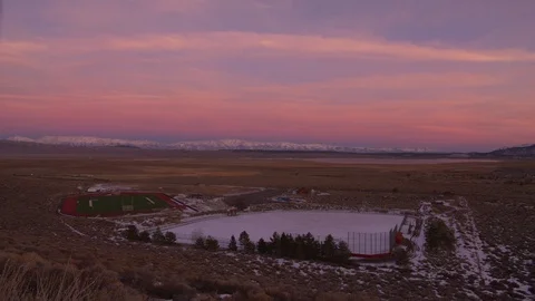 Pink and Blue Sunset with Sprawling Fields and Snow Covered Mountains Stockbeeldmateriaal 124594532