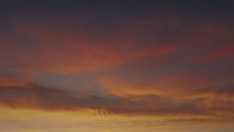 Pink and Orange Clouds Glowing in Dramatic Sunset Sky Stock Footage 340190822