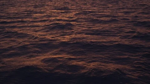 Pink and orange sunset reflection on water surface high angle 4k Stockbeeldmateriaal 123258918