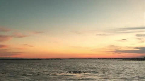 Pink And Orange Twilight Sky Over Calm Lake Water In Rural Cambodia Stock Footage 341647857
