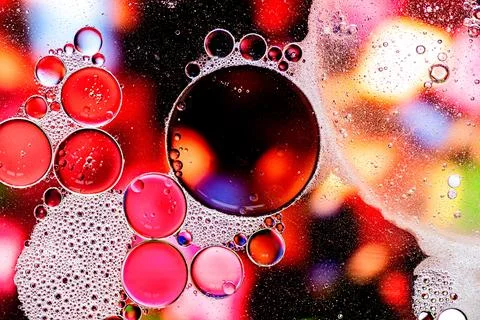 Pink and purple abstract pattern made with oil bubbles on water Stock Photos