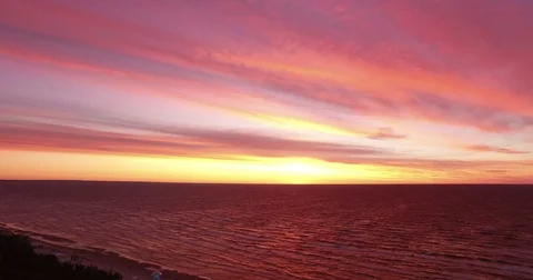 Pink and red sunset over the sea. Filmed from sky Stock Footage 71644146