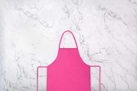 Pink apron on marble background. Flat lay 스톡 사진