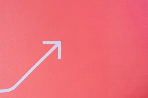 Pink arrow pointer on the wall with empty space Stock Photos