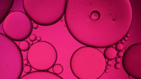 Pink artistic of oil drop floating on the water. Pastel color bubble for backgro Stock Footage 256731455