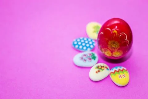 On a pink background close-up of colored Easter eggs and cupcake, holiday bac Stock Photos