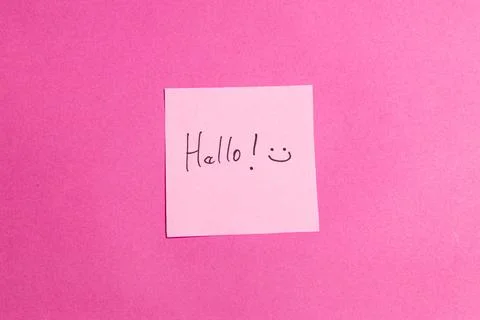 A pink background with a pink sticky note that says "Hello!" on it Stock Photos