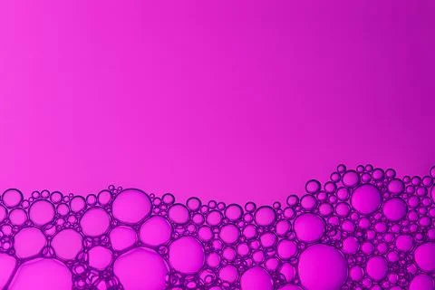 A pink background with a purple line of bubbles Stock Photos