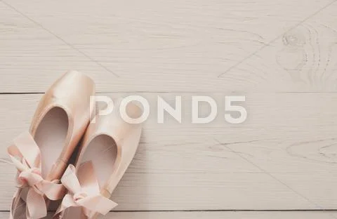 Pink ballet pointe shoes on white wood background Stock Photos
