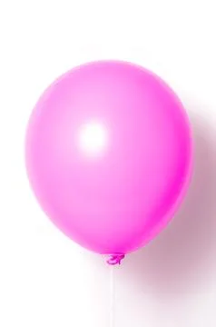 Pink balloon on white background with shadow. Side glare. Stock Photos