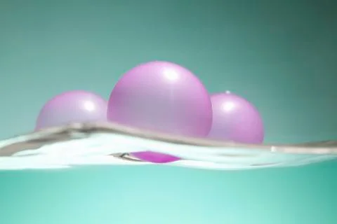 Pink balloons floating on water surface Foto stock
