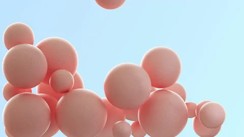 Pink balls of different diameters fall on a blue background, particles of pastel Stock Footage 143580805