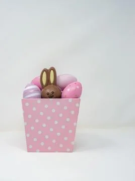 Pink basket with Easter eggs and bunny Stock Photos