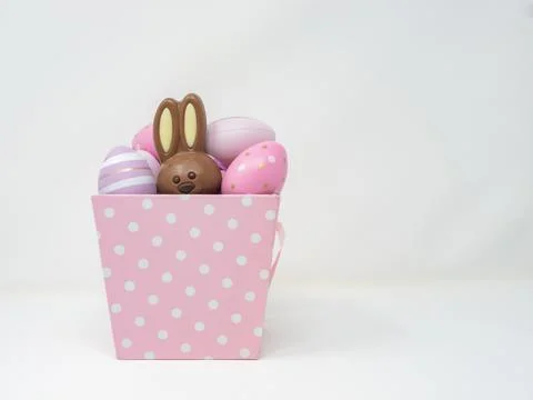 Pink basket with Easter eggs and bunny Stock Photos