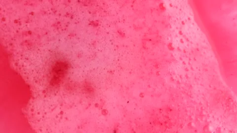 Pink bath bomb ball dissolves in water with bright pink foam bubbles. Cosme.. Stock Footage 273676445