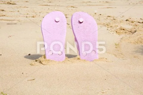 Pink Beach Flip Flops With In White Sand On Sea Background