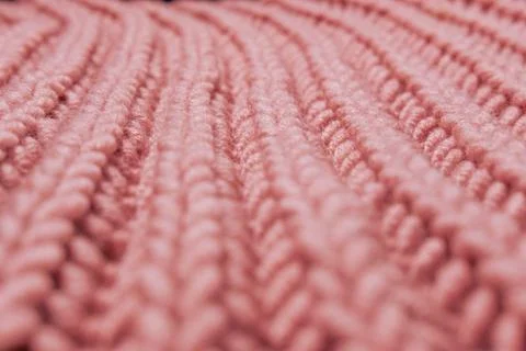 Pink beautiful knitted braid pattern of light natural wool yarn, knitted te.. Stock Photos