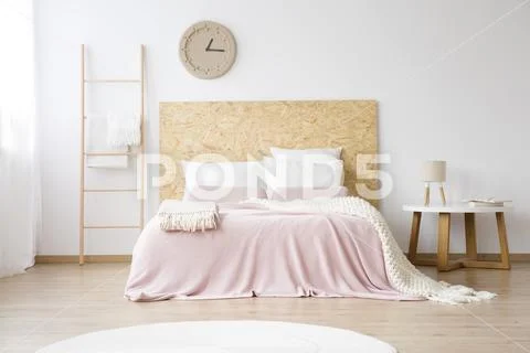 Pink bedsheets on king-size bed Stock Photos