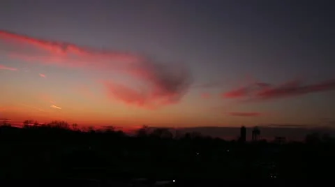 Pink blue red sunset with many colors time lapse car traffic in background Stock Footage 18487060