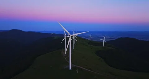 Pink Blue Vibrant Sky Wind Generators On Mountain Top Aerial Scene Close Up Video stock 300488262