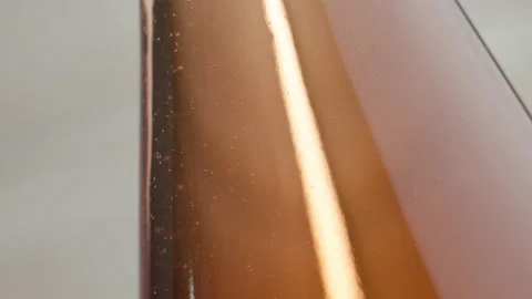 A pink bottle of cider. Bubbles Floating. Macro shot. Stock Footage 147343972