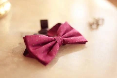 Pink bowtie on table Stock Photos