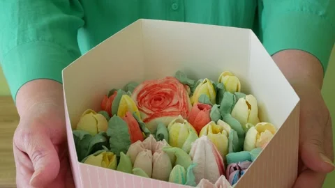 A pink box filled with colored meringue cookies as flowers in hands, Gift b.. 스톡 동영상 295215134