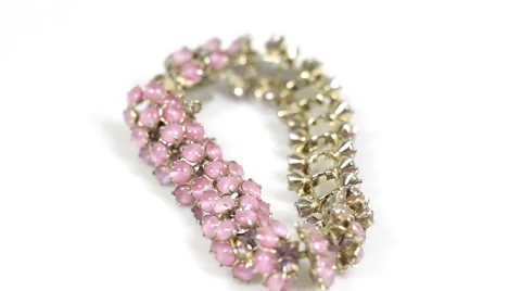 Pink bracelet rotating on white background Stock Footage 40479004
