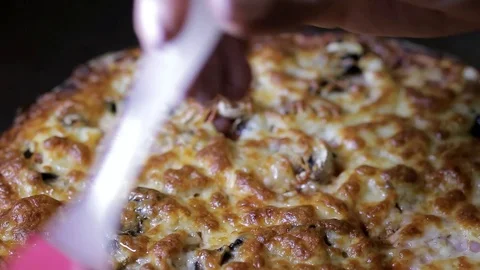 Pink brush lubricates the surface of a hot pizza Stock Footage 102709051