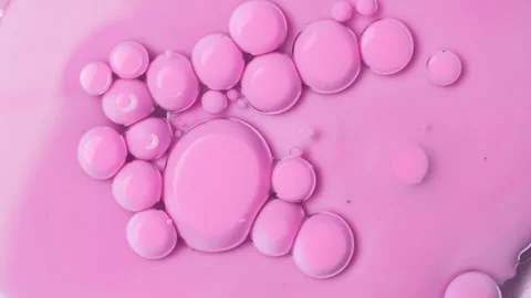 Pink bubbles of paint on an oil surface. Acrylic paint. Abstract background. Stock Footage 266973731