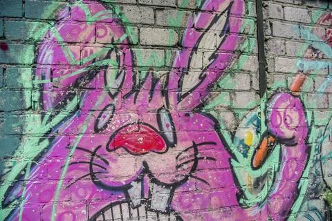A pink bunny was sprayed as graffiti on an old wall Stock Photos