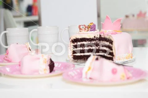 Pink cake of a little princess with a crown and animal figures. Birthday one Stock Photos