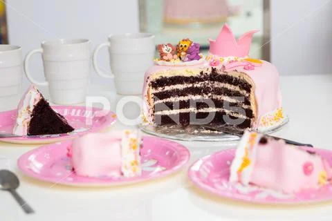 Pink cake of a little princess with a crown and animal figures. Birthday one Stock Photos