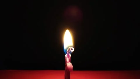 Pink candle burning on a red surface Stock Footage 317900964