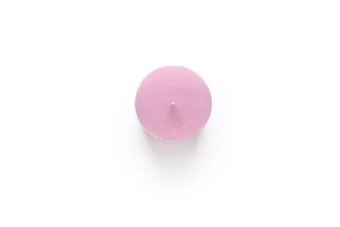 Pink candle on white background. Stock Photos
